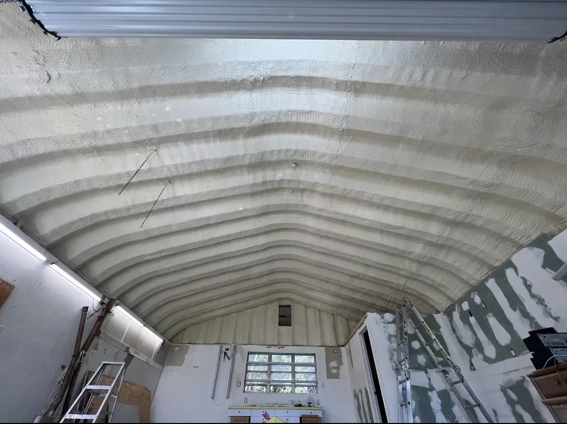 Spray polyurethane foam applied to the underside of a metal roof deck in Dunn